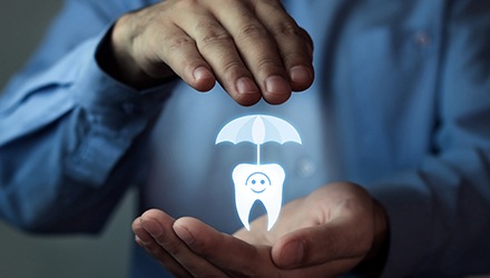 Man holding animated tooth under umbrella