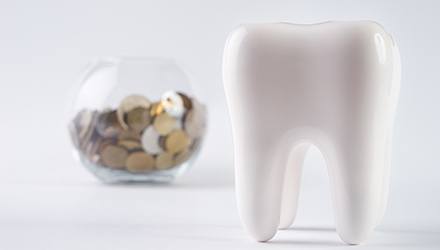 Tooth with bowl of coins